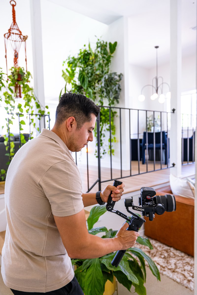 Stillwater videographer working a handheld rig through an interior