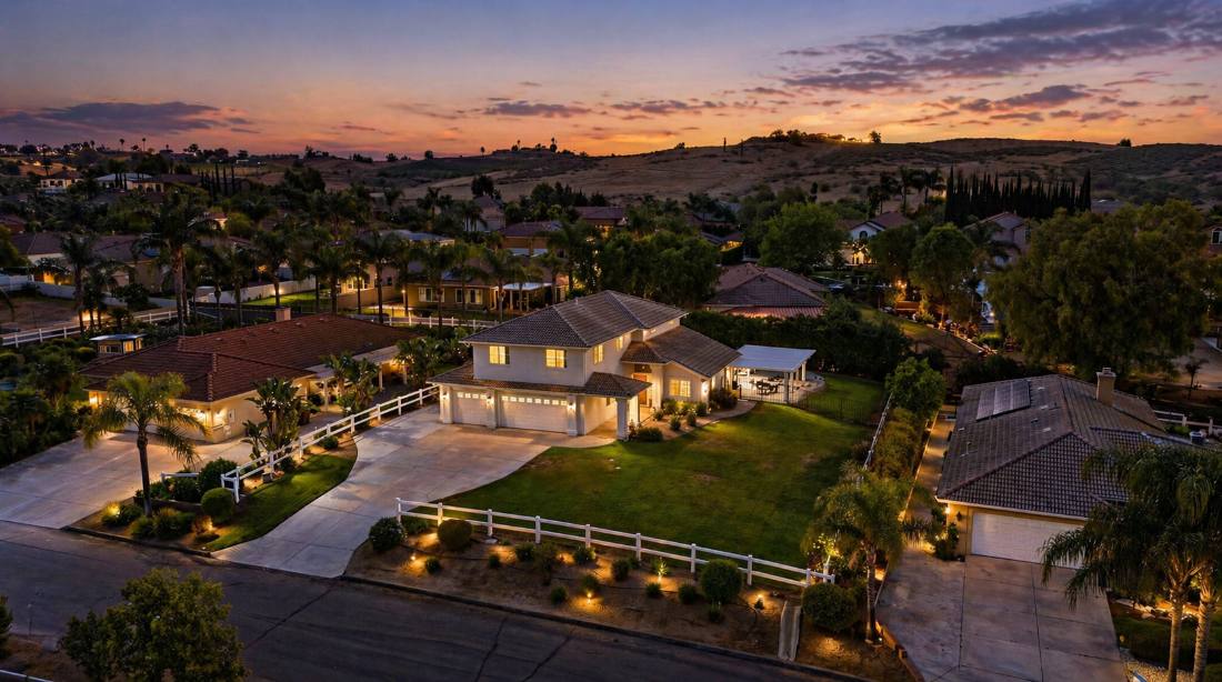 Twilight aerial, ranch estate with landscape lighting