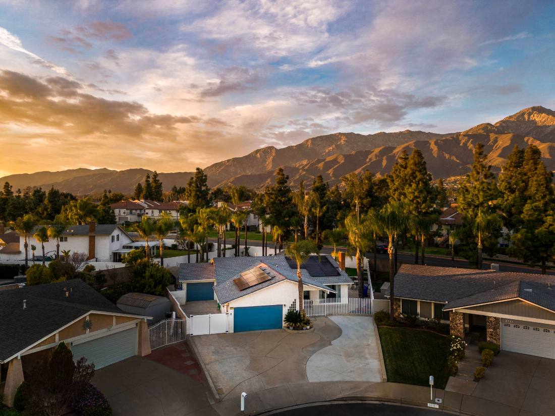 Sunset aerial, foothill neighborhood under the mountains