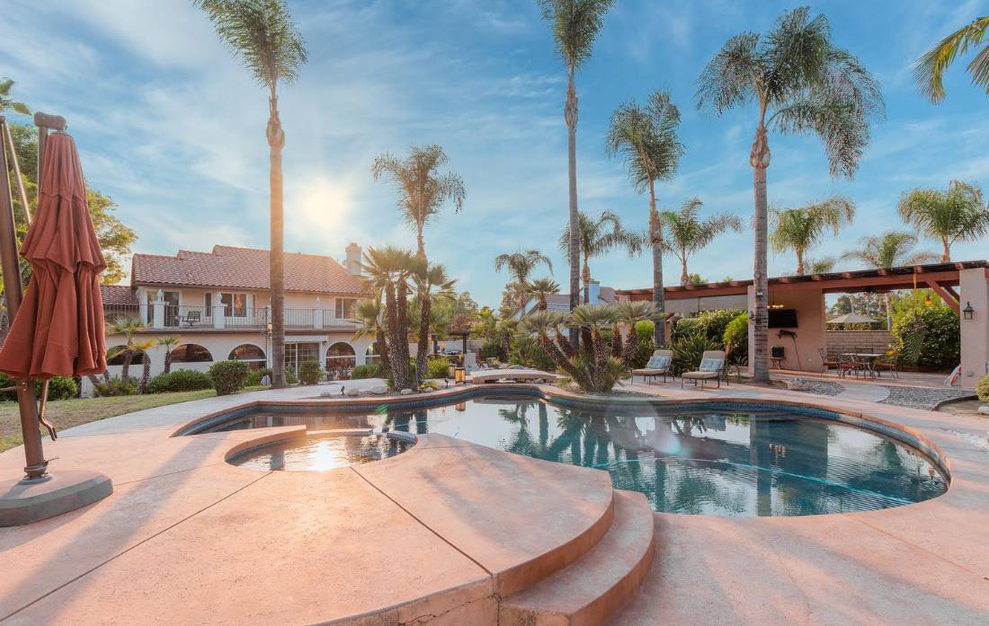 Backyard resort, palms and pool at golden hour